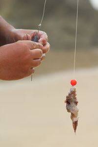 Close-up of hand holding fishing rod