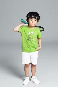 Portrait of boy standing against white background