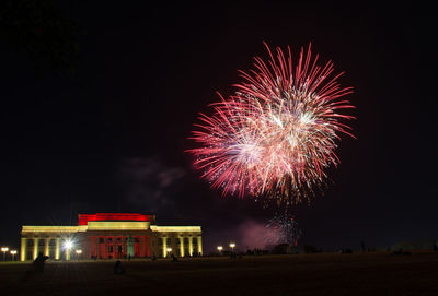 Low angle view of firework display at night