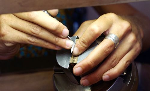 Close-up of hands holding metal