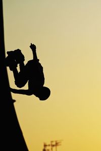 Man photographing through camera at sunset