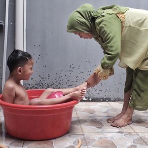 Mid adult man standing in water