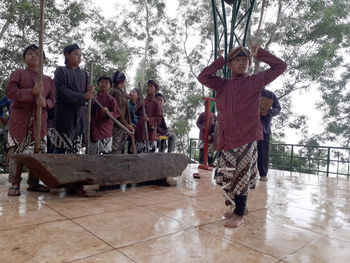 Group of people standing on wet floor during rainy season