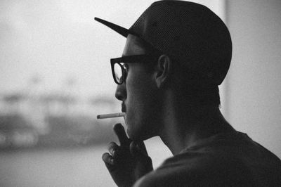 Side view of man smoking a cigarette