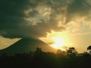 Scenic view of silhouette mountains against sky at sunset