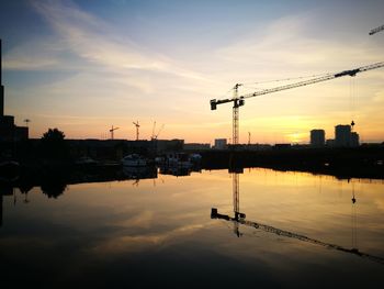 Scenic view of silhouette city against sky during sunset