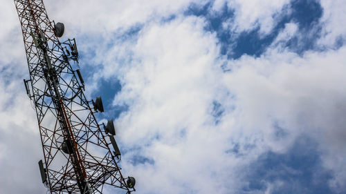 Low angle view of telecommunications tower against sky