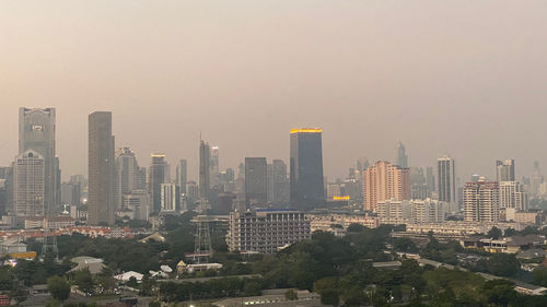 Modern buildings in city against clear sky