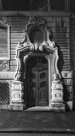 Low angle view of illuminated statue against building