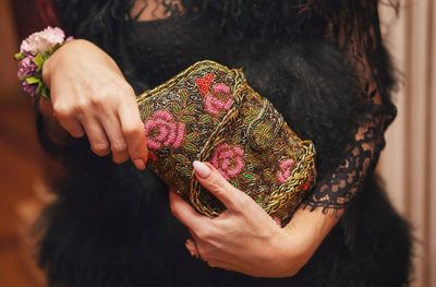 Close-up mid section of a woman holding purse