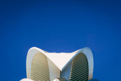 Low angle view of skyscraper against clear blue sky