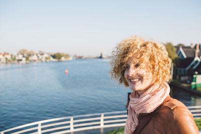 Smiling woman against river