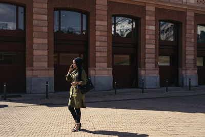 Rear view of woman standing on street