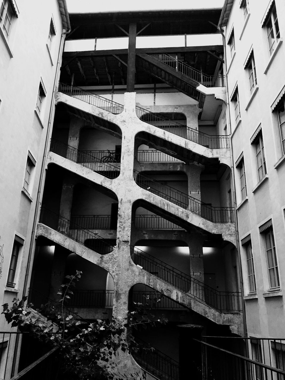 architecture, built structure, building exterior, low angle view, window, building, railing, staircase, steps and staircases, residential building, balcony, residential structure, steps, in a row, repetition, no people, day, outdoors, house, city