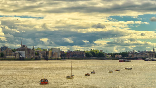 View of cityscape against cloudy sky