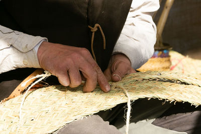 Craftsman's hands, working the esparto grass, handicrafts in the street