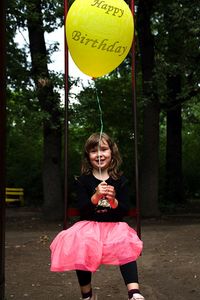 Girl holding balloons