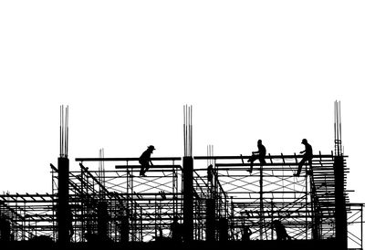 Low angle view of silhouette people on construction site against clear sky