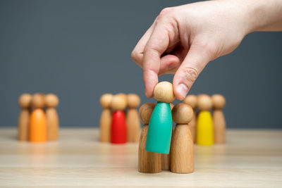 Close-up of hand holding toy blocks on table