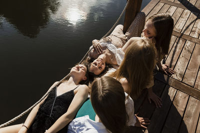 Smiling women lying on friends lap