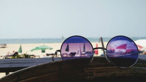 Close-up of sunglasses on railing