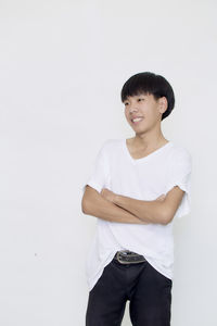 Portrait of boy standing against white background