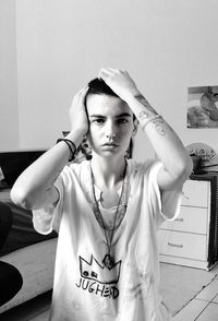 Portrait of young androgynous person in black and white with short hair buzz cut and emotional scene