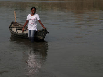 Girl standing on river water