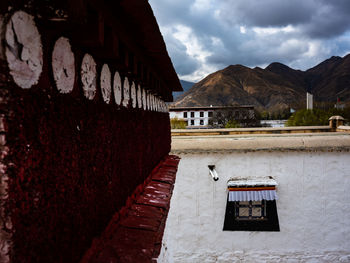 Exterior of old building by mountain against sky