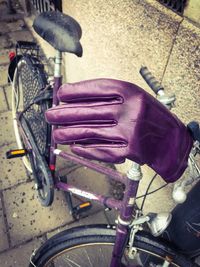 Close-up of hand holding bicycle on street