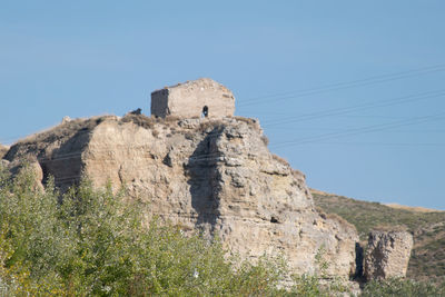 Low angle view of old ruins against clear blue sky