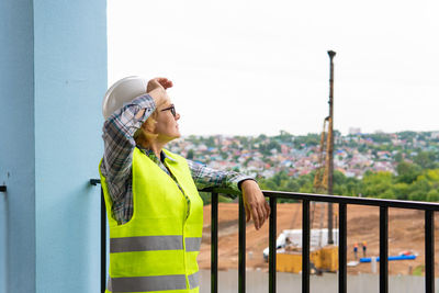 Man standing by railing