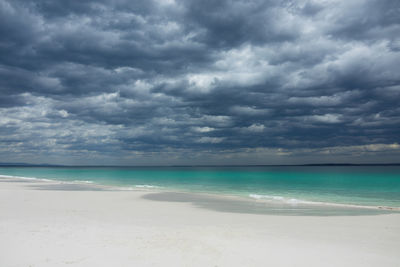 Scenic view of sea against storm clouds