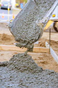 Close-up of wood on sand at construction site