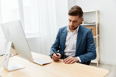 Young man working at desk in office