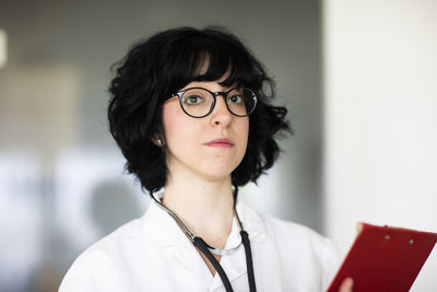 Young female doctor with white coat