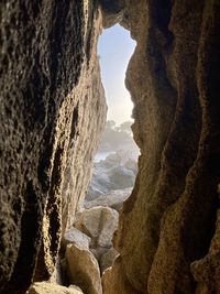 Rock formations in sea against sky