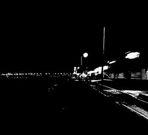 Illuminated city against clear sky at night