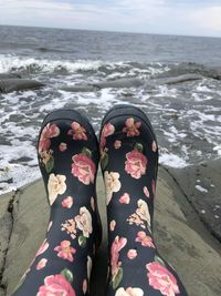 Low section of man relaxing on beach