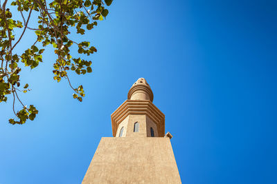 Low angle view of building against clear blue sky