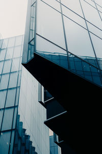 Low angle view of modern building against blue sky