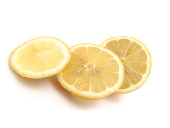 Close-up of lemon slice against white background