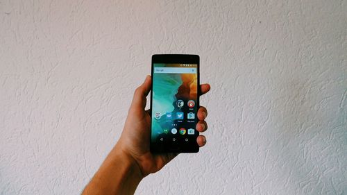 Cropped image of woman photographing through smart phone