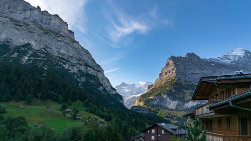 Scenic view of houses and mountains against sky