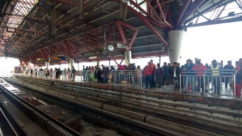 People waiting at railroad station platform