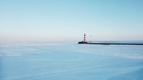 Scenic view of sea against clear sky during winter