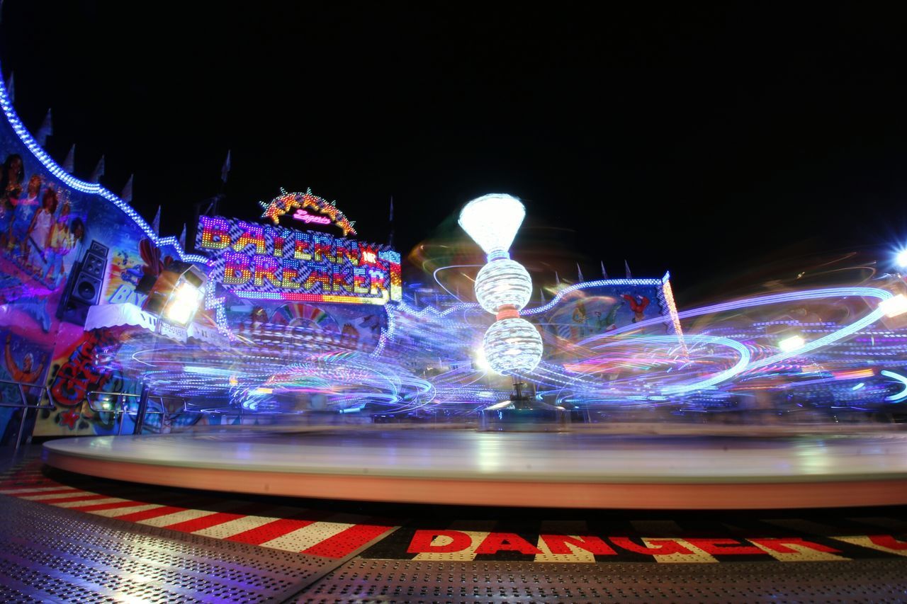 illuminated, night, motion, blurred motion, long exposure, amusement park, speed, light trail, glowing, amusement park ride, multi colored, lighting equipment, no people, arts culture and entertainment, representation, city, outdoors, creativity, light - natural phenomenon, light painting