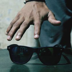Close-up of hand holding sunglasses