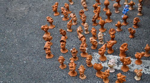 High angle view of clay figurines on footpath