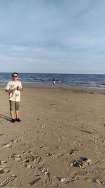 People on beach against sky